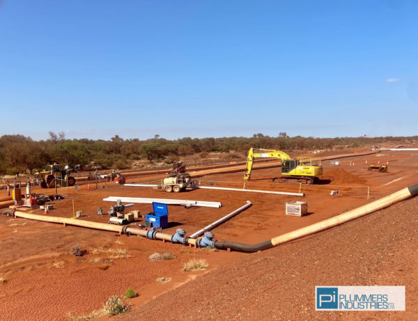 A construction site with various pipes and equipment, showcasing the use of piping solutions.