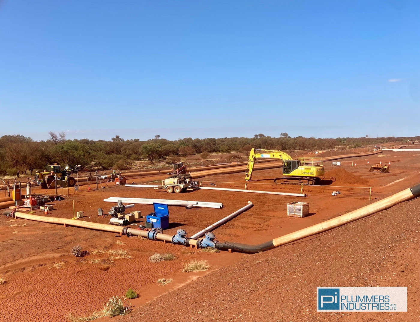 A construction site with various pipes and equipment, showcasing the use of piping solutions.