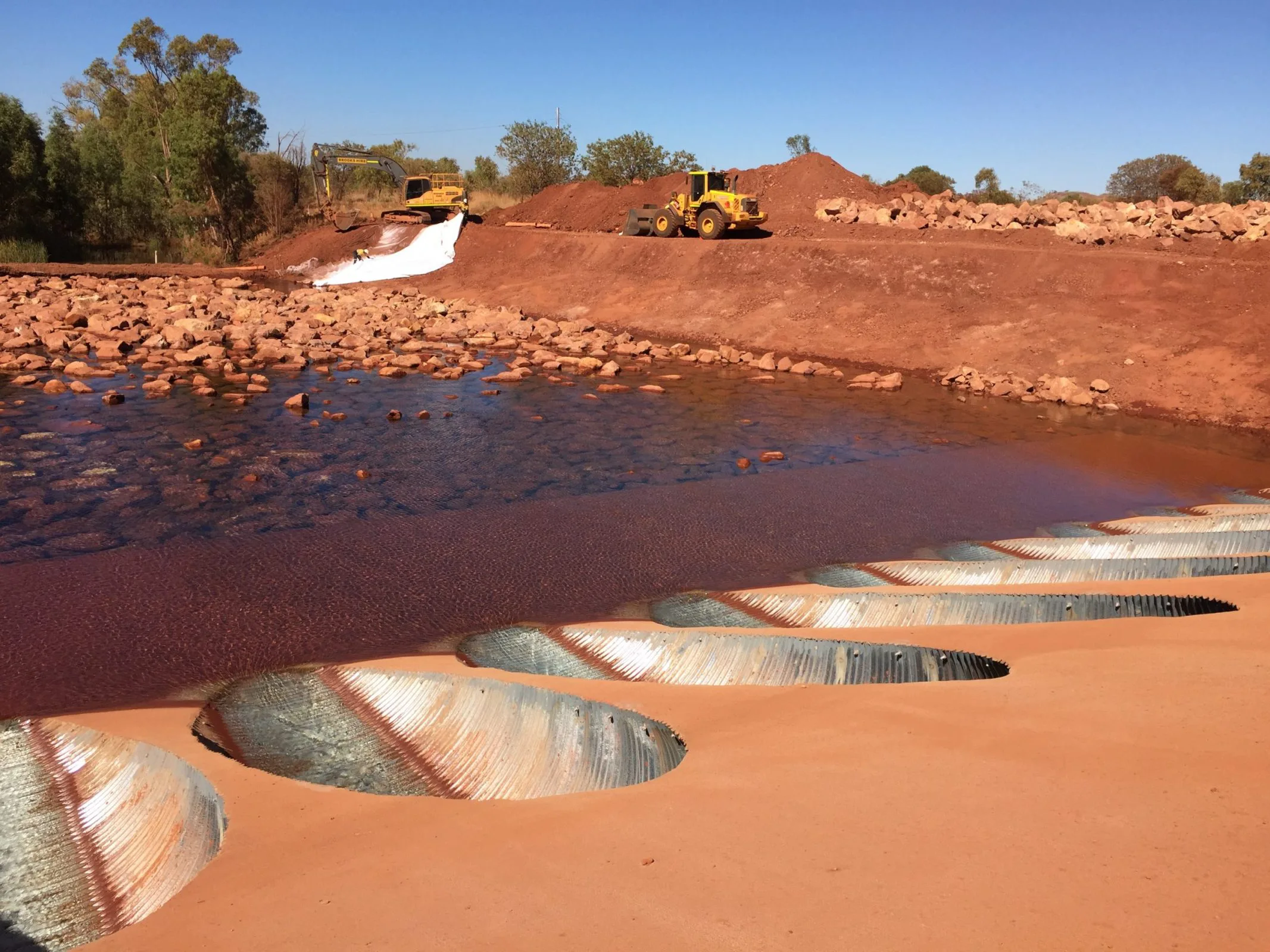 A civil construction image showing a large water tank with a sizable pipe inside.