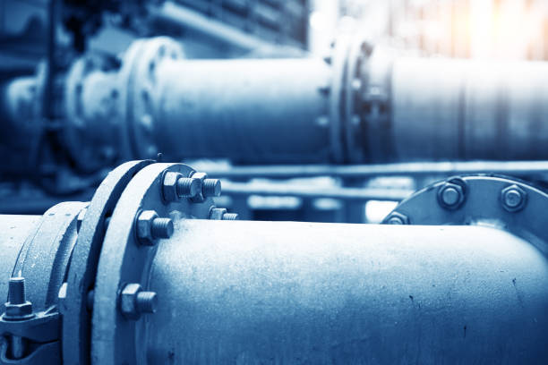 Industrial pipes and valves in a factory, part of the infrastructure pipeline.